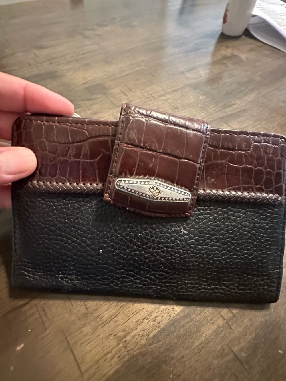 Brighton leather bi-fold featuring a black pebbled leather brown croc emboss